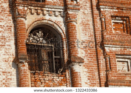 old ruined building. red bricks. window with lattice