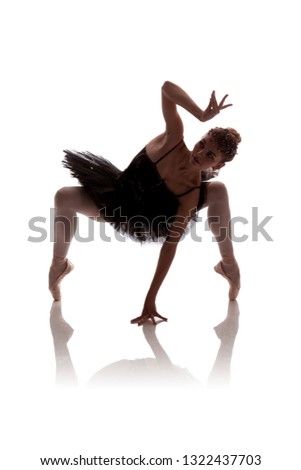 woman ballerina in black pack posing on white background
photo made in the style of "low key"