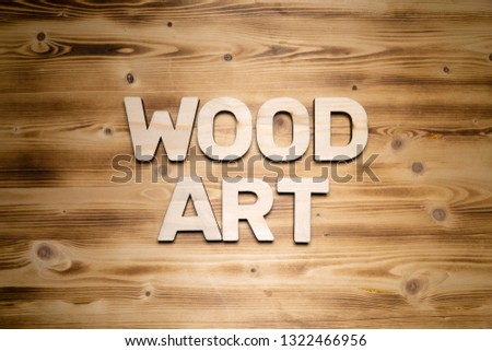WOOD ART words made of wooden block letters on wooden board.