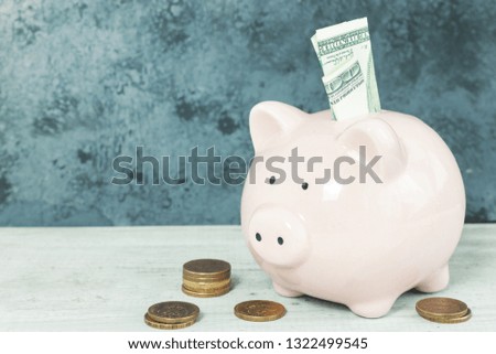 Piggy bank money on table on gray background. Savings concept.