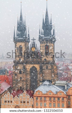 Church Of The Virgin Mary Before Tyn in snowfall. City overview with red roof from the Tower of Old Town Hall. Concept: Travel Prague, Travel Blogging, Travel Europe