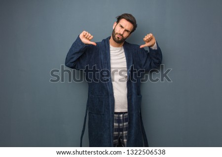 Man wearing pajama pointing fingers, example to follow