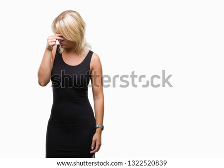 Young beautiful blonde attractive woman wearing elegant dress over isolated background tired rubbing nose and eyes feeling fatigue and headache. Stress and frustration concept.