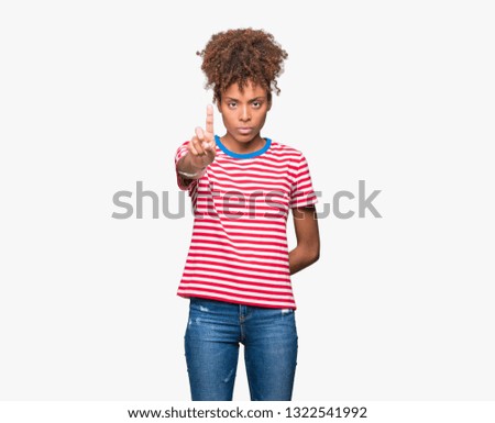 Beautiful young african american woman over isolated background Pointing with finger up and angry expression