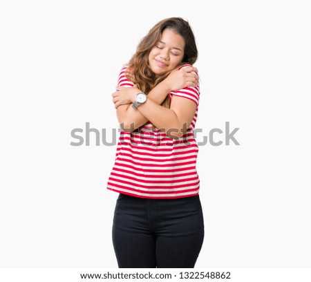 Young beautiful brunette woman wearing stripes t-shirt over isolated background Hugging oneself happy and positive, smiling confident. Self love and self care