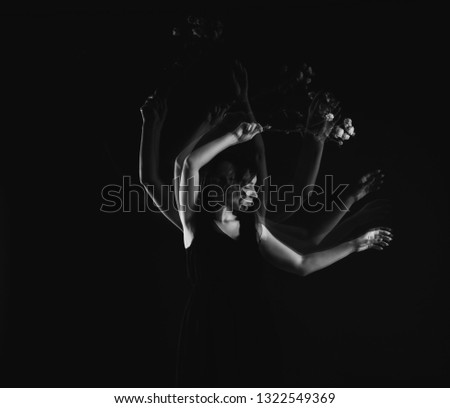 Stroboscopic photo of beautiful moving young woman on dark background