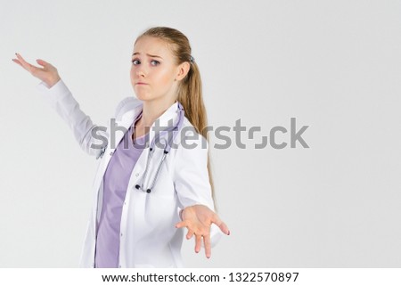 Girl doctor blond young light background studio day beautiful one spread her arms. No understanding knowing failure places to take patient assist.