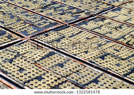 Kerupuk,  Javanese traditional crackers drying under the sun.  Royalty-Free Stock Photo #1322581478