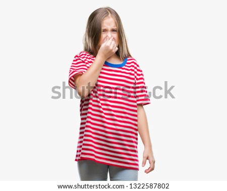 Young beautiful girl over isolated background smelling something stinky and disgusting, intolerable smell, holding breath with fingers on nose. Bad smells concept.