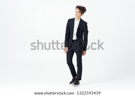 Business man in a dark suit in full growth on a light background office worker