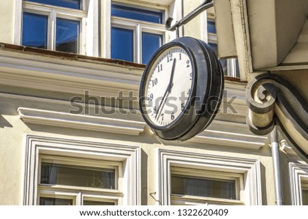 Around clock in the ancient style weigh on the corner of an ancient building 