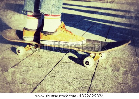 skateboarder rides a skateboard in orange sneakers, theme of leisure and lifestyle