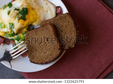 breakfast of scrambled eggs on a dark background
