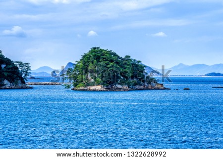 Many small islands over the blue ocean in sunny day, famous Kujukushima(99 islands) pearl sea resort islet in Sasebo Saikai National Park, Nagasaki, Kyushu, Japan.