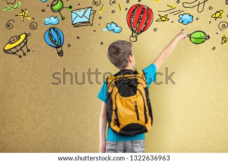 back view of cute kid imagine space travel with set of infographics over textured wall background