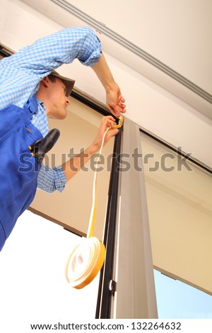 Professional sealing a window frame Royalty-Free Stock Photo #132264632