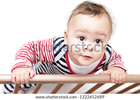 little baby boy in bed looking for his mother with white background with people stock photo