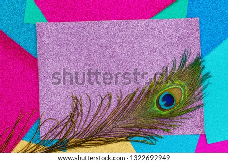 Carnival shiny background with colorful peacock feathers on lila glitter paper, copy space, text place. Christmas, New Year, Silvester metallic shimmers background 