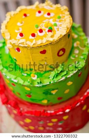Sweet paper birthday cake painted with 
 gouache. Decorated with punch paper and other home made decorations and glitter.