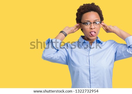 Young beautiful african american business woman over isolated background Smiling pulling ears with fingers, funny gesture. Audition problem