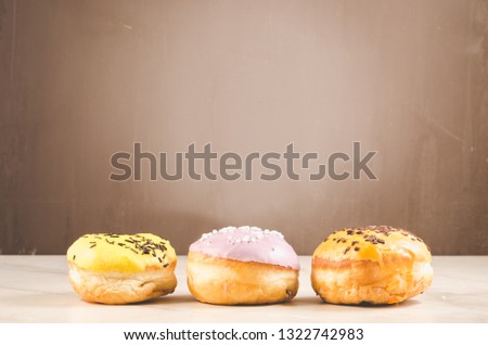 Donuts. Assorted donuts lying on a white table on background with copy space. Сoncept sweet food