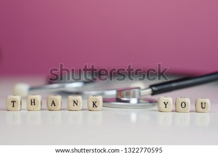 Text of THANK YOU as Conceptual photo. Greeting to medical professionals. Selectively focused and isolated on plain background.