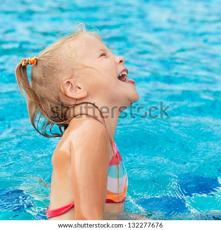 little girl playing in the swimming pool