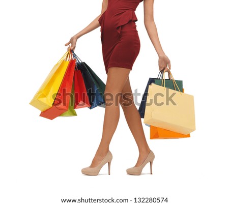 picture of woman's long legs with shopping bags.