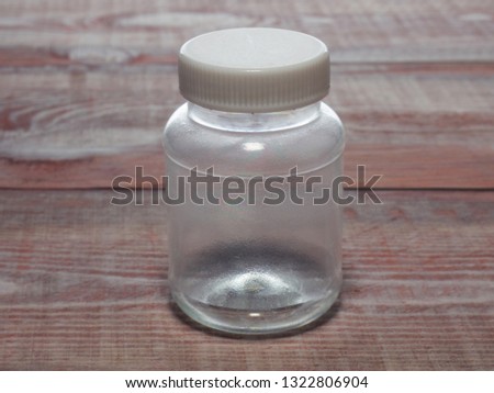 Transparent plastic bottle on a wood background. Concept No plastic