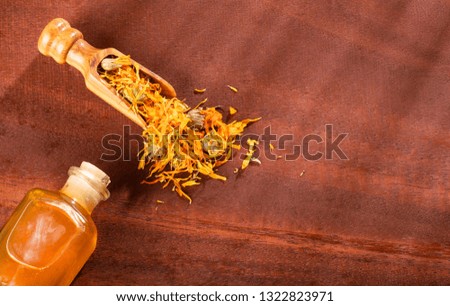 Aromatherapy essential oil with marigold flowers - Calendula officinalis.