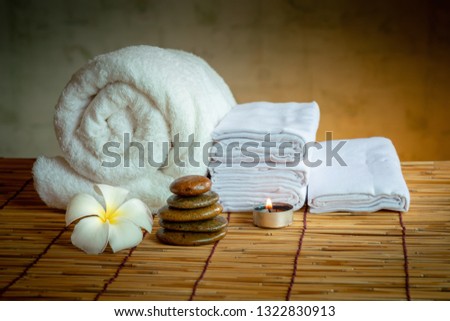 Spa Oil Massaging Treatment and Skincare Concept., Component of Therapy Massage With Plumeria or Frangipani Flowers, Towel, Stones, Aroma Candle and Oil on The Desk.