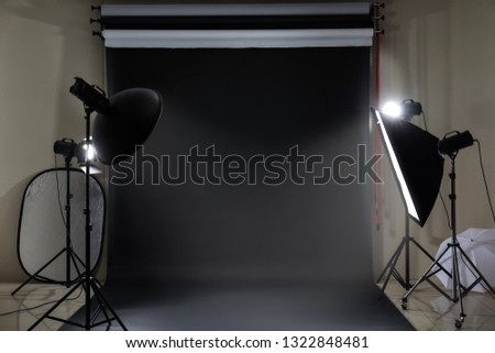 Interior of modern photo studio with professional equipment Royalty-Free Stock Photo #1322848481