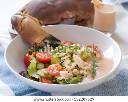 Crab salad with rice and fresh vegetables, selective focus