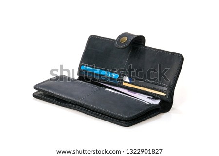 Leather wallet in hands with cash, credit cards and smartphone