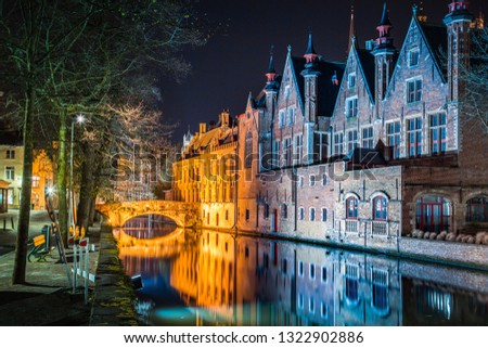 Classic panoramic twilight view of the historic city center of Brugge during beautiful evening blue hour at dusk, province of West Flanders, Belgium