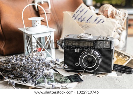 Beautiful vintage composition with old camera,dry lavender, black and white photos and old letters. Romantic retro background.