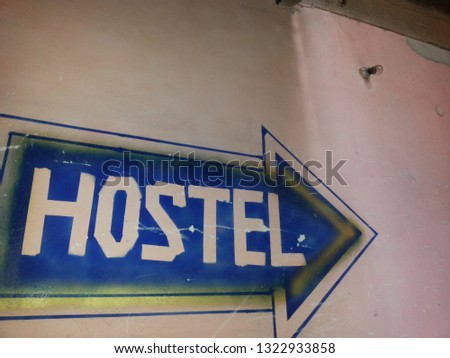 hostel blue arrow sign