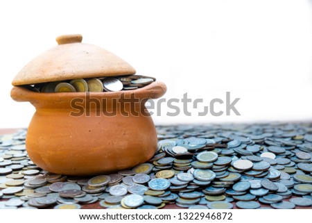 Coins in jar from on pile lots coin with white background, Money stack for business planning investment and saving concept