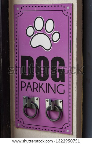 Dog parking area designated with two rings to tie the strap