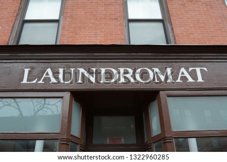 Sign for a Laundromat on Front of Building 