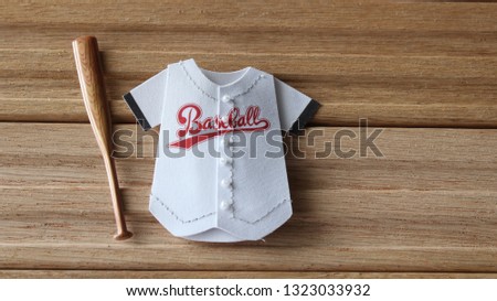Baseball journey with bat close up laying flat on a wood background with writing space