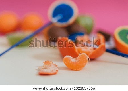 Different kinds of fruit photographed on colorful background and painted with different colors.