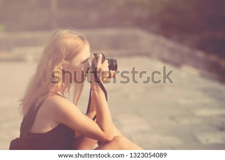 Woman with camera on the street summer photography