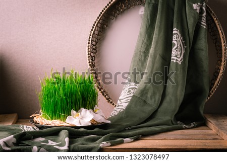 Novruz still life with semeni sabzi wheat grass , silk national scarf, eastern musical instrument and orchids. Spring equinox in March celebration, copy space 