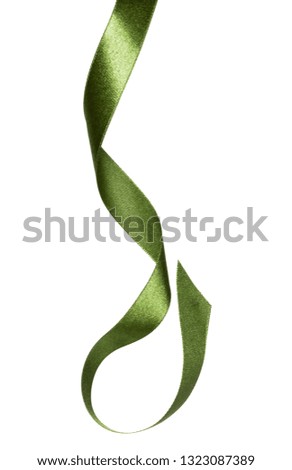 Shiny satin ribbon in green color isolated on white background close up. Ribbon image for decoration design.