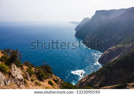 Rocky coast of the Atlantic ocean at 
Madeira archipelago in Portugal at sunny day. Mountains, rocks and ocean. Fantastic beautiful landscape of island.


