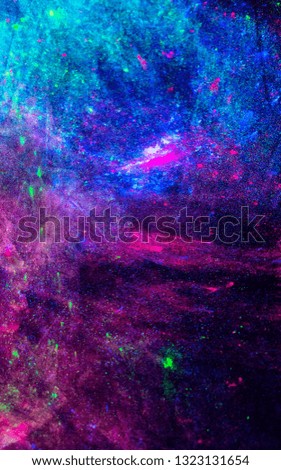 Neon colors on black fabric, neon background, texture. Colorful dark bright background. Neon paint scattered on a dark surface