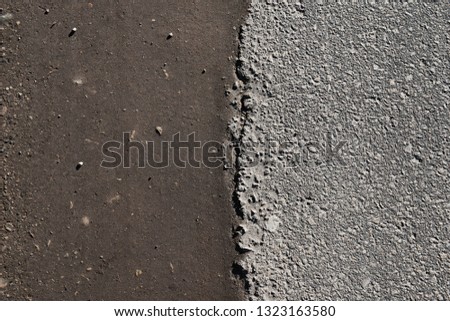 Road with a lot of cracked asphalt parts together next to ground