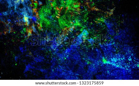 Neon colors on black fabric, neon background, texture. Colorful dark bright background. Neon paint scattered on a dark surface