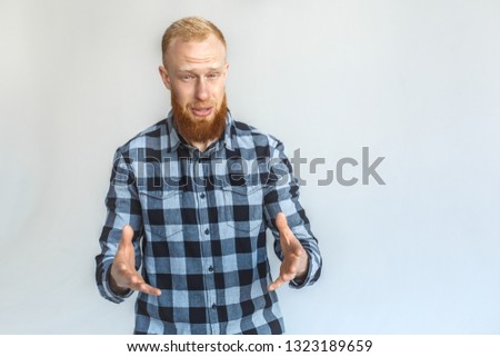 Red hair mature man standing isolated on grey wall hands poiting at camera confused